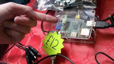 Andrew Conroy helpfully pointing out a Raspberry Pi (in a case) because it's so small it's hard to spot