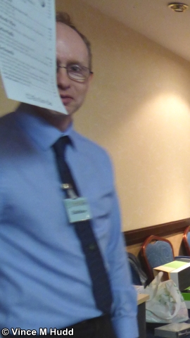 Andrew Conroy trying to hide from the camera behind a piece of paper at Wakefield 2018